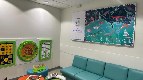 Jurassic Coast artwork installed in the Weymouth UTC children’s waiting area, part of healthcare design for children’s waiting areas by Grosvenor Interiors.